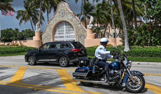 Local law enforcement officers are seen in front of the home of former President Donald Trump at Mar-A-Lago in Palm Beach, Florida, on Tuesday.
