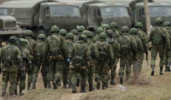 Soldiers who were among several hundred that took up positions around a Ukrainian military base walk towards their parked vehicles on March 2, 2014, in Perevalne, Ukraine.