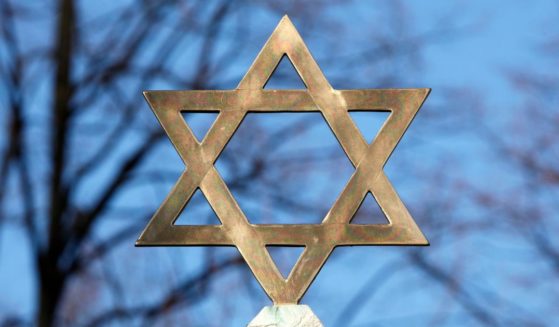 A star of David is seen on top of a gravestone in this stock image.