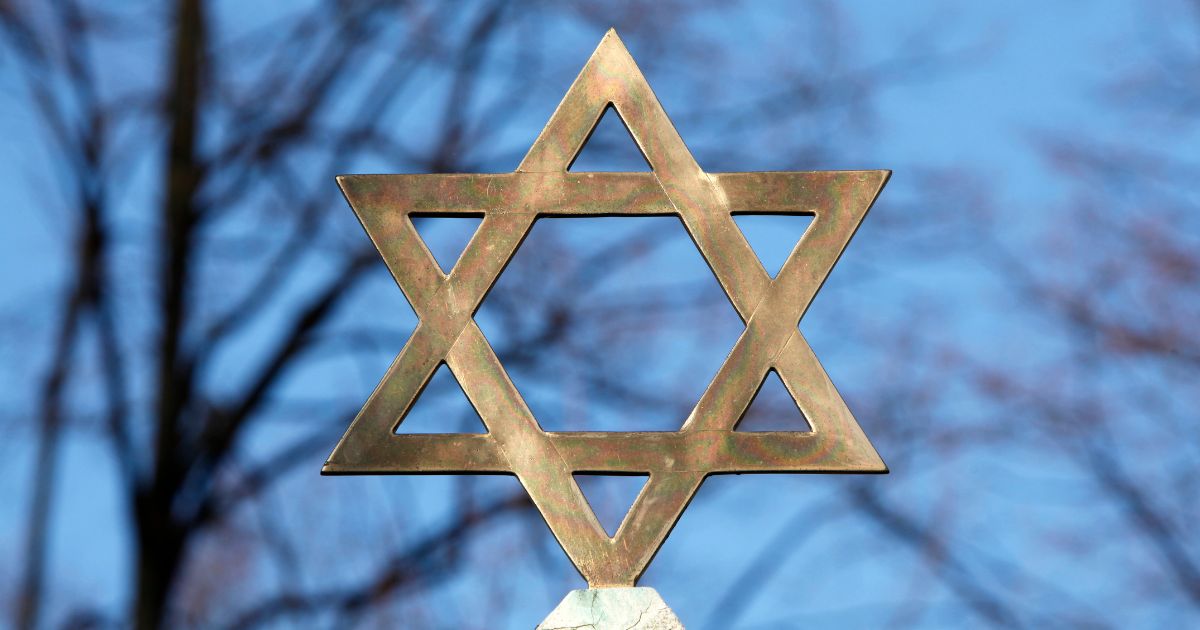 A star of David is seen on top of a gravestone in this stock image.