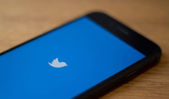 The Twitter logo is seen on a phone in this photo illustration.