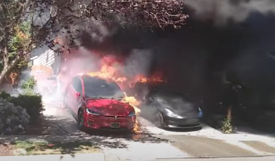 A fire burns a Tesla electric vehicle Sunday in Lynnwood, Washington.