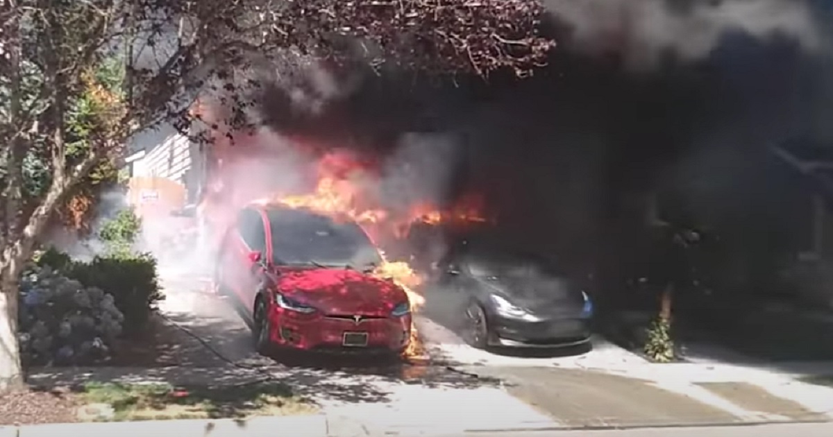 A fire burns a Tesla electric vehicle Sunday in Lynnwood, Washington.