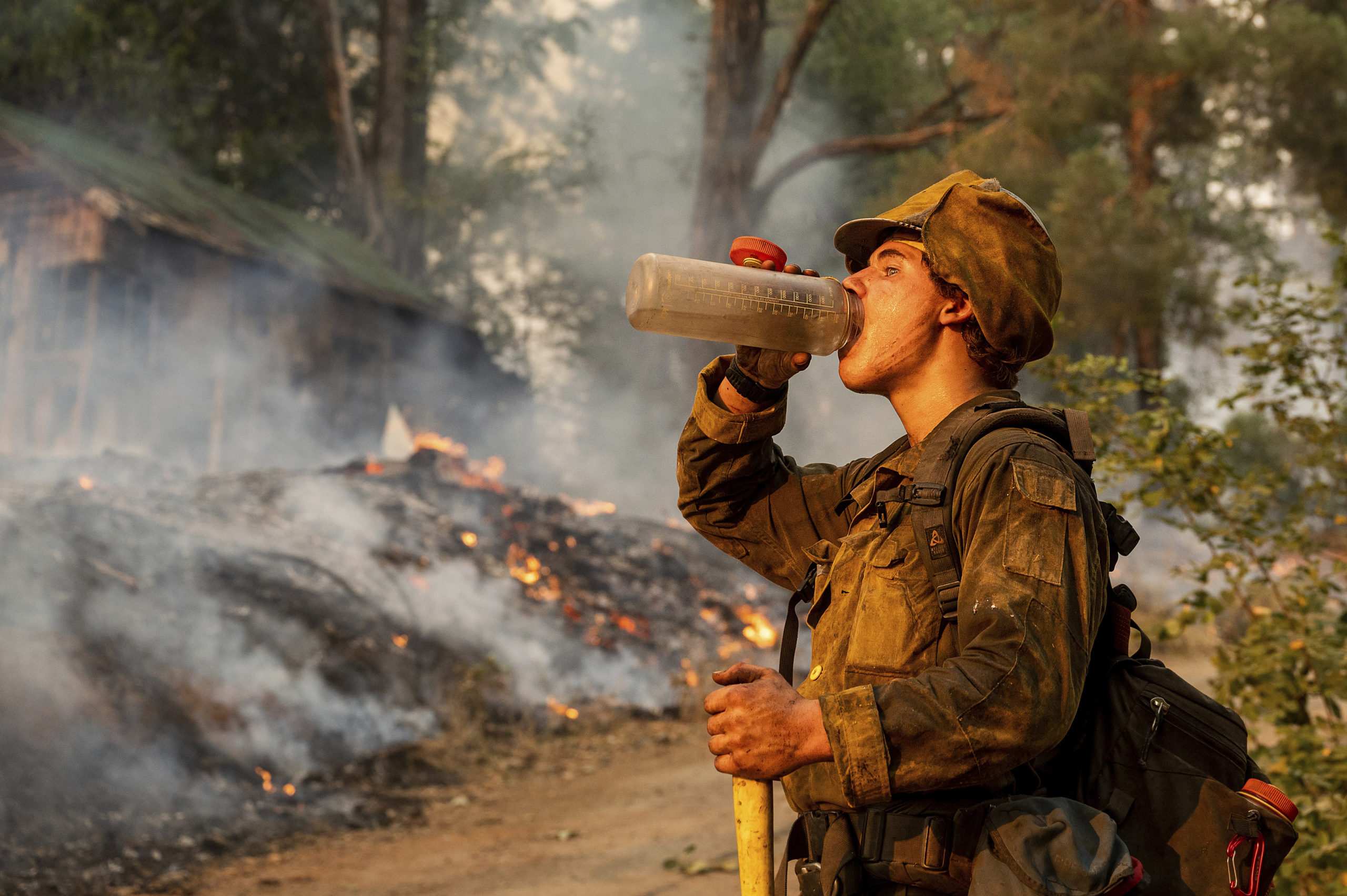 Firefighter Trapper Gephart of Alaska's Pioneer Peak Interagency Hotshot crew takes a drink while battling the Mosquito Fire in the Volcanoville community of El Dorado County, California, on Friday.