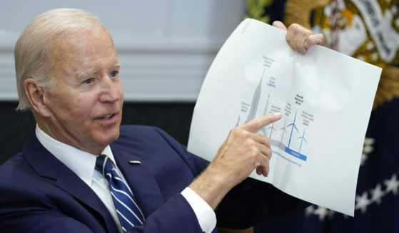 President Joe Biden points to a wind turbine size comparison chart during a meeting in the Roosevelt Room of the White House in Washington on June 23.