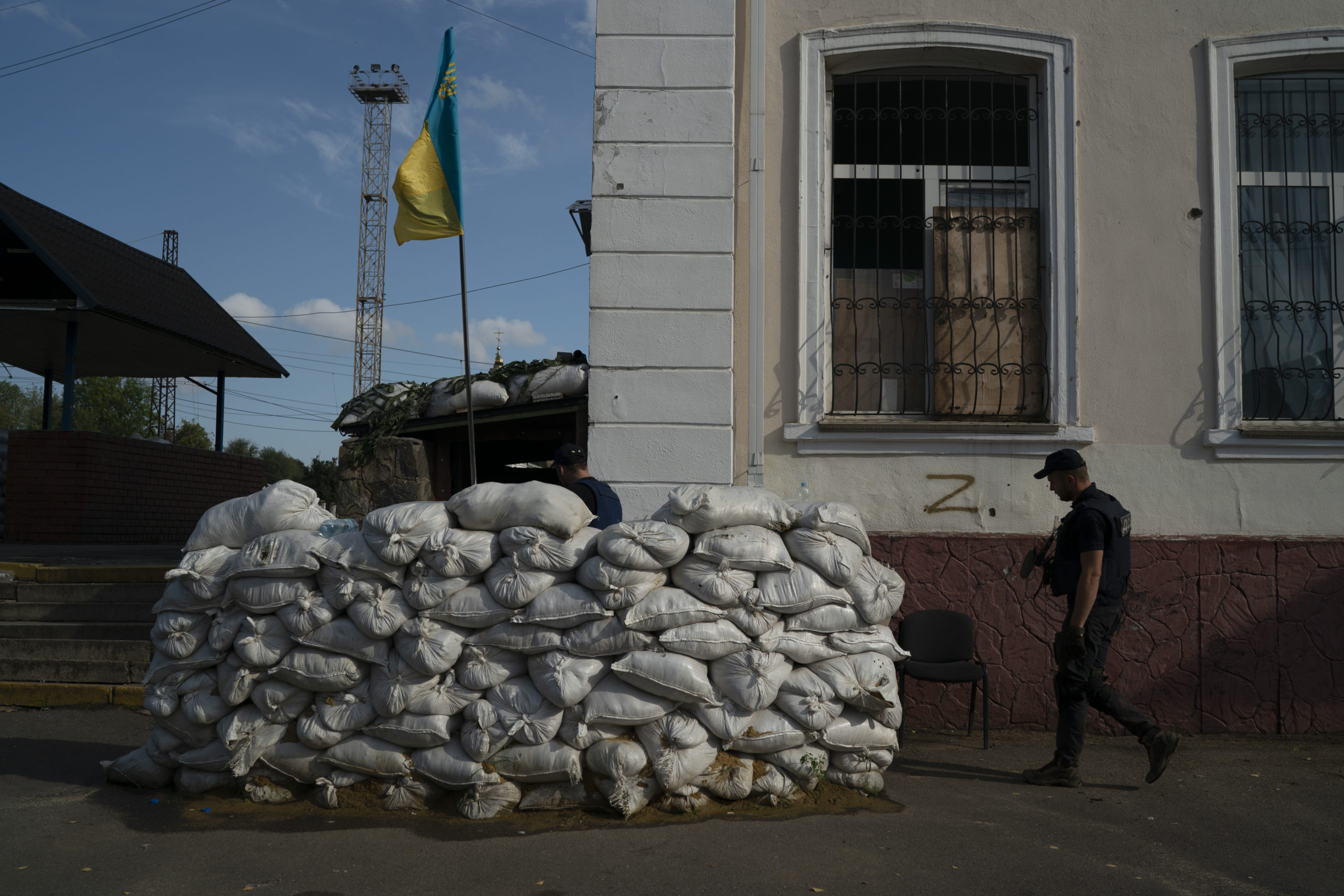 On Sunday, a man with the State of Emergency Service of Ukraine enters the basement of a train station that is fortified with sand bags, which was used as an interrogation room during Russian occupation, in Kozacha Lopan, Ukraine.
