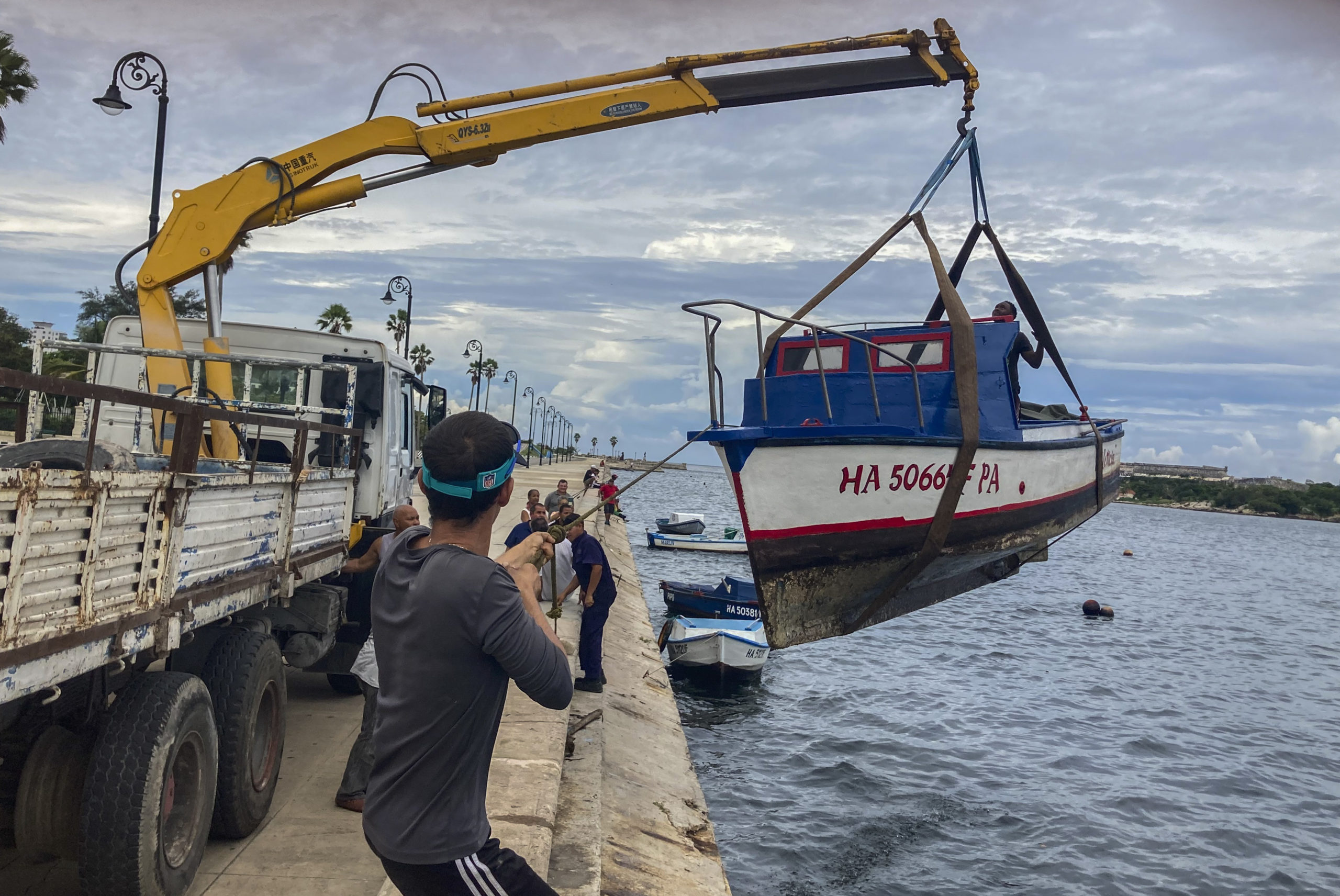 On Monday, workers move a boat out from the water in the bay of Havana, Cuba, as Hurricane Ian prepared to hit Cuba.