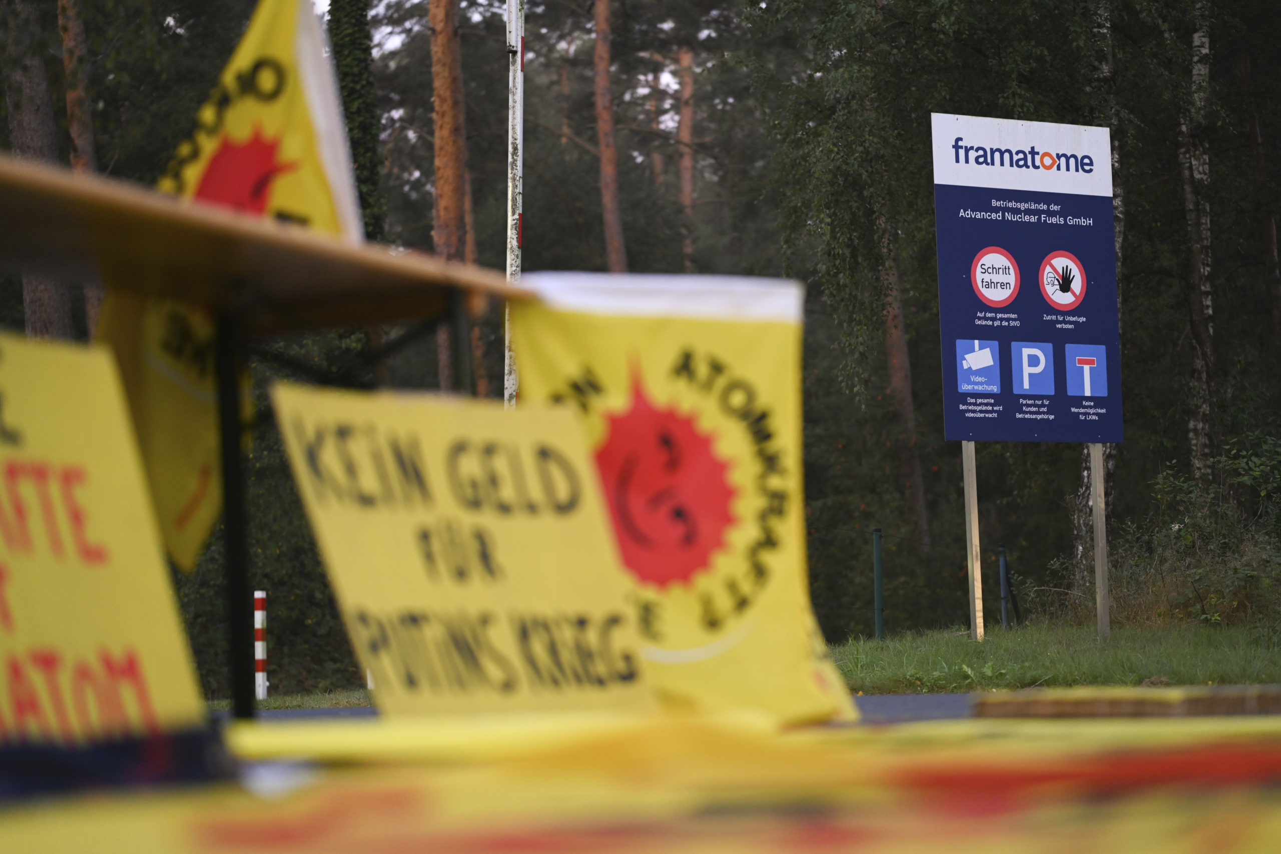 Protest posters are seen outside the fuel element fabrication plant of the Framatome company in Lingen, Germany, on Monday, after the Germany government said it would not be able to stop Russia from shipping uranium through the country and processing it at a site in Germany.