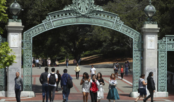 Students at the University of California at Berkeley in Berkeley, California, walk through the Sather Gate on May 10, 2018.