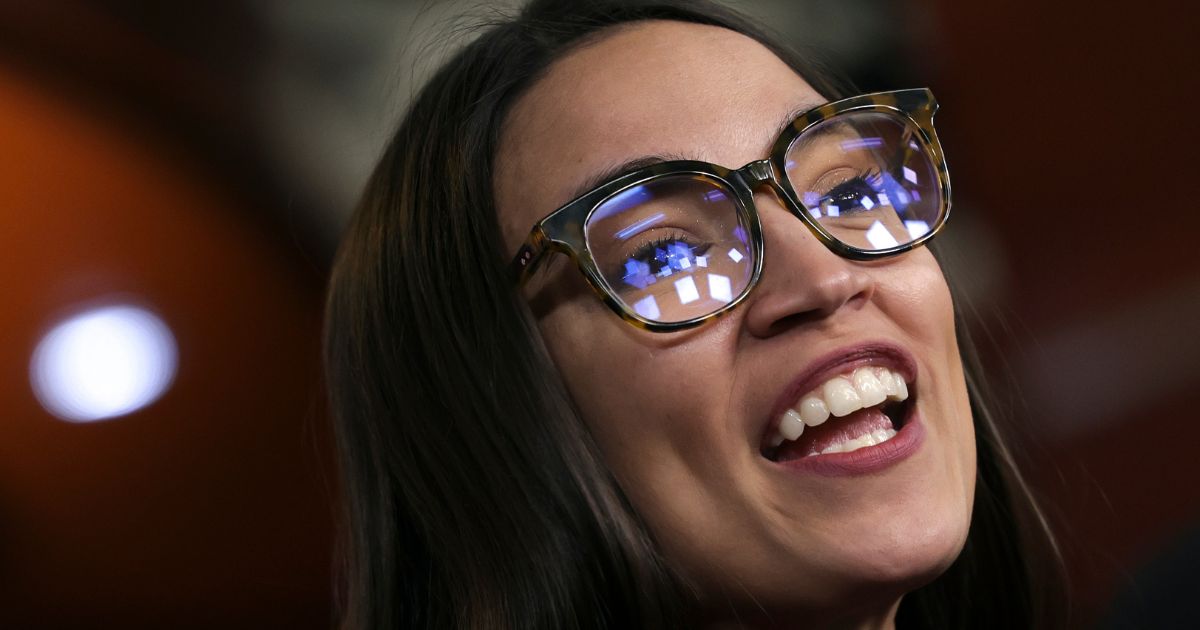 Rep. Alexandria Ocasio-Cortez speaks about banning stock trades for members of Congress during a news conference in Washington, D.C., on April 7.