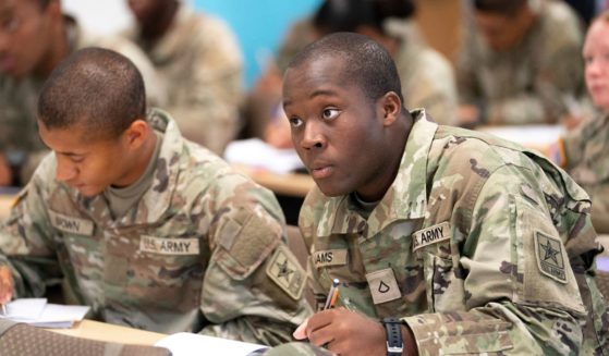 Army recruits listening to an instructor