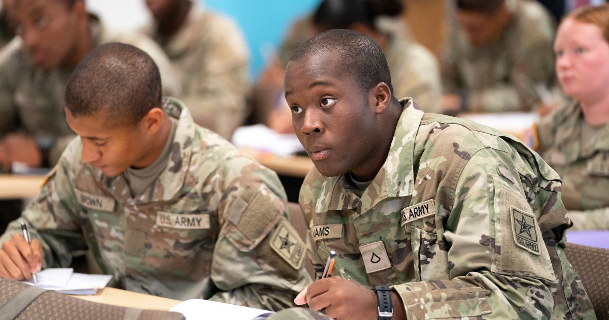 Army recruits listening to an instructor