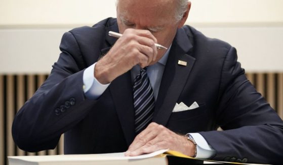 President Joe Biden signs the condolence book at the British Embassy in Washington to pay his respects following the death of Queen Elizabeth II on Thursday.