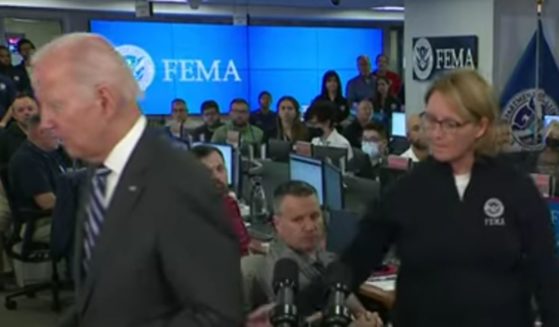 FEMA Administrator Deanne Criswell tries to redirect President Joe Biden as he shuffles away from the podium