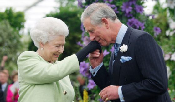 Then-Prince Charles kisses the hand of his mother, Queen Elizabeth II, during a visit to the Chelsea Flower Show in London on May 18, 2009.