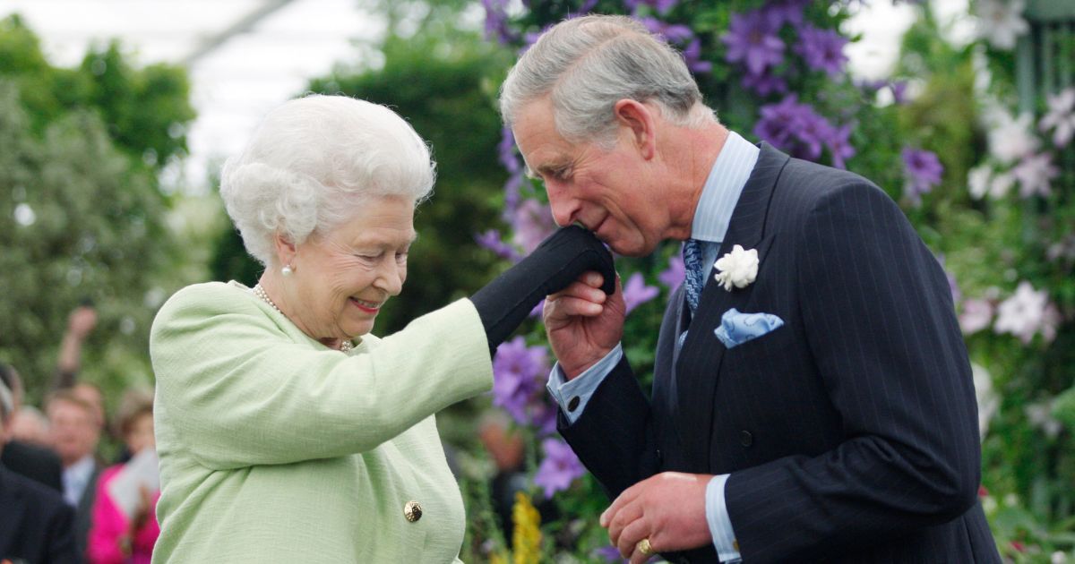 Then-Prince Charles kisses the hand of his mother, Queen Elizabeth II, during a visit to the Chelsea Flower Show in London on May 18, 2009.