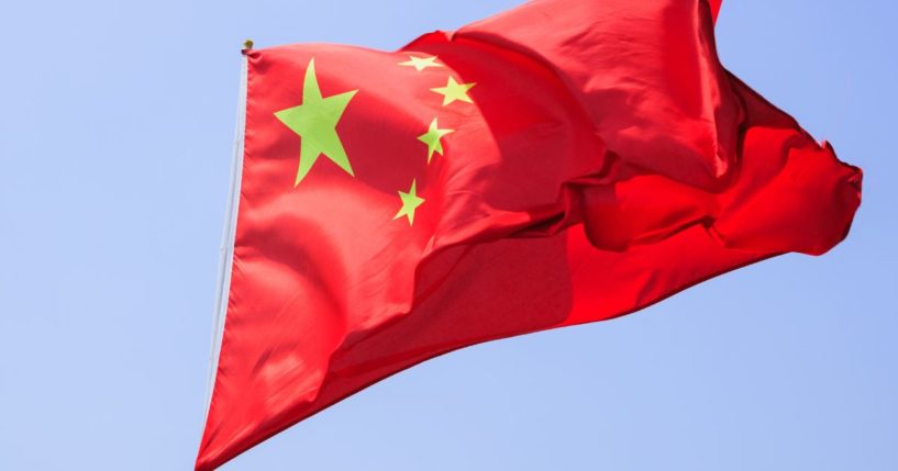 A Chinese flag flies in this stock image.