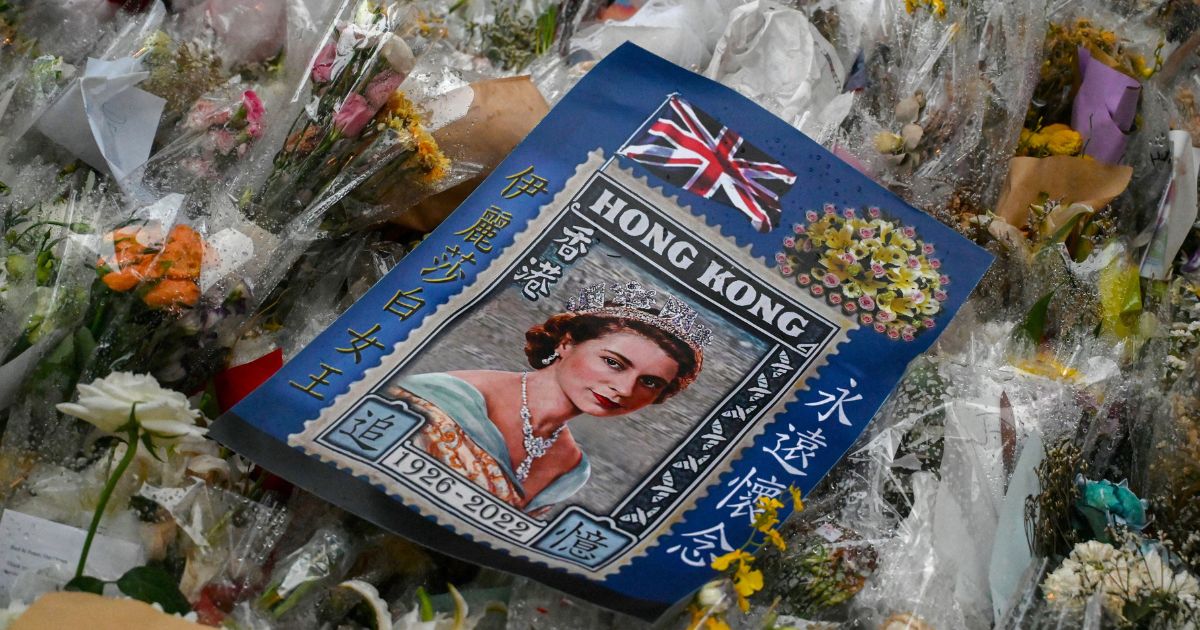 An image of Queen Elizabeth II is placed amongst flower tributes outside the British Consulate in Hong Kong on Monday.