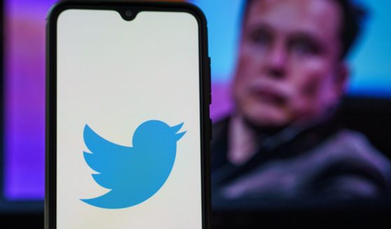 The Twitter logo is seen on a cellphone screen in this stock image.