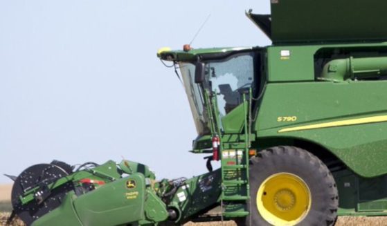 A shattered window on the cab of a John Deere combine is seen at the site of where four people were killed in a reported murder-suicide in Towner County, North Dakota.