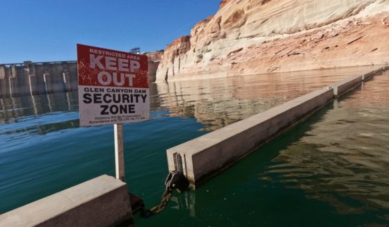 A "Keep Out" sign is displayed just upstream of Glen Canyon Dam at Lake Powell in Page, Arizona, on June 8, as America's large reservoirs on the Colorado River drop to record-low levels.