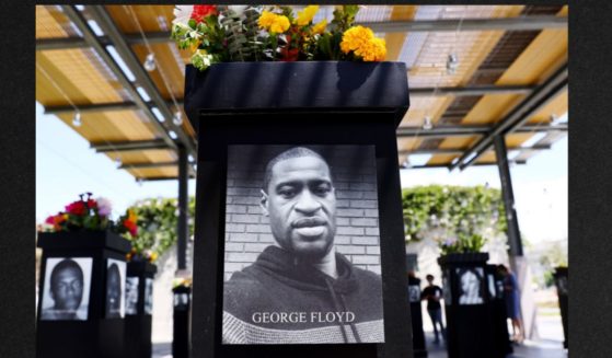 A photograph of George Floyd is displayed along with other photographs at a memorial exhibit in July of 2021 in San Diego, Calif.