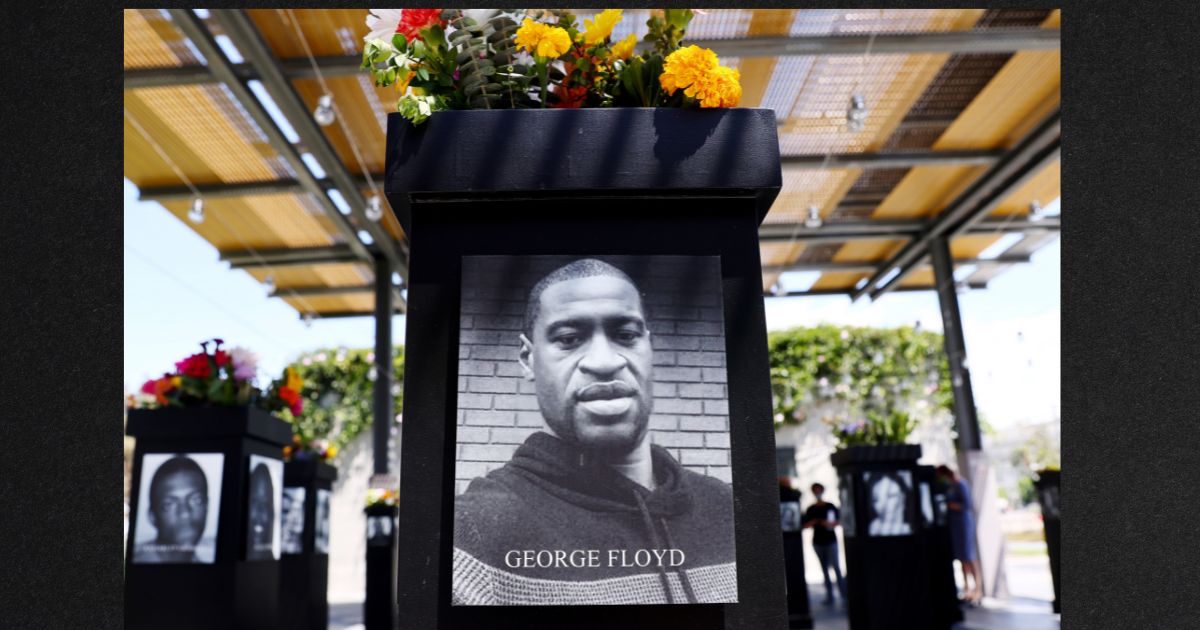 A photograph of George Floyd is displayed along with other photographs at a memorial exhibit in July of 2021 in San Diego, Calif.
