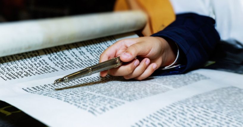 A Jewish boy reads the Hebrew Bible in this stock image.