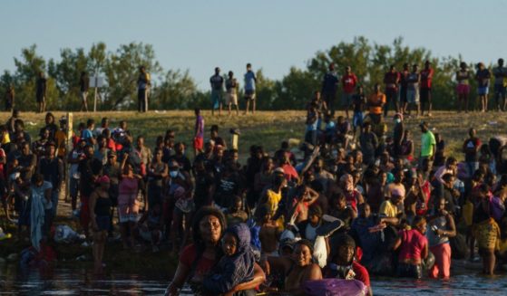 A large group of Haitian migrants cross the U.S.-Mexico border via the Rio Grande river near Cuidad Acuna, Coahuila state, Mexico on Sept. 20, 2021.