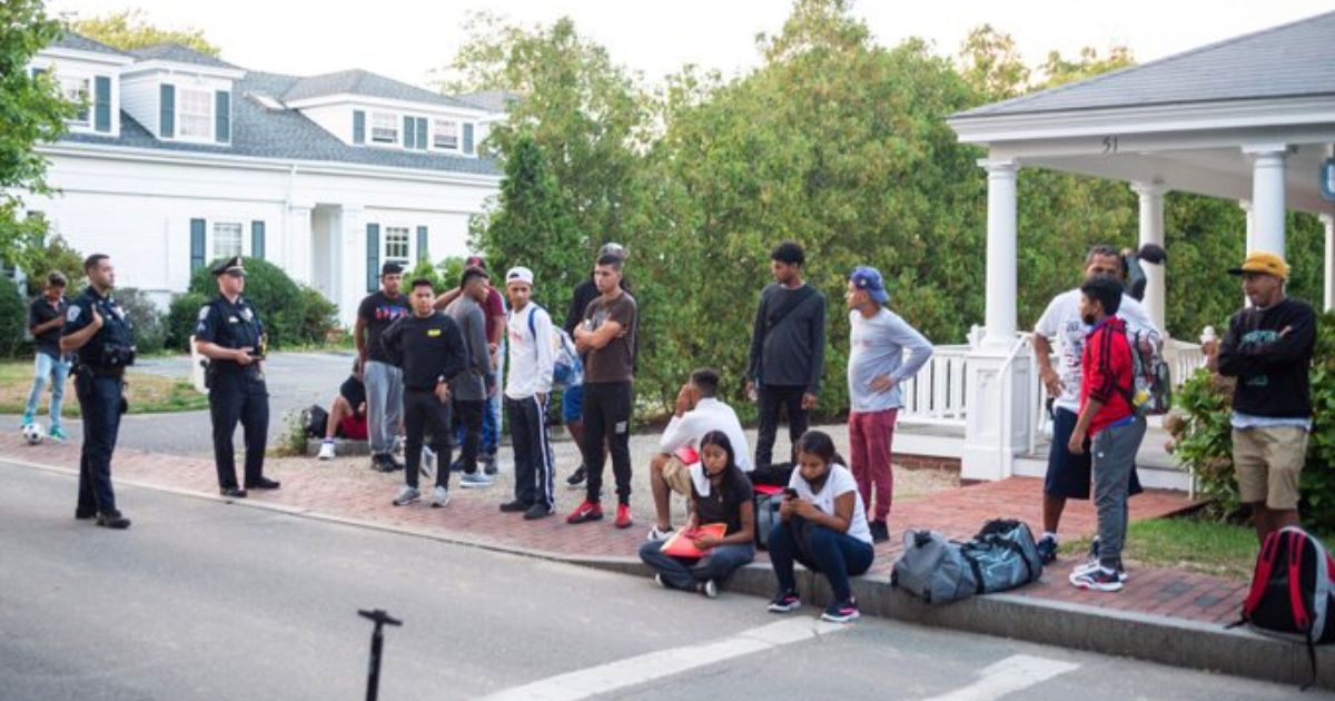Police watch over the illegal immigrants who arrived on Massachusetts' Martha's Vineyard on Wednesday.