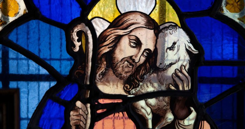 Jesus holds a lamb in this stock image.