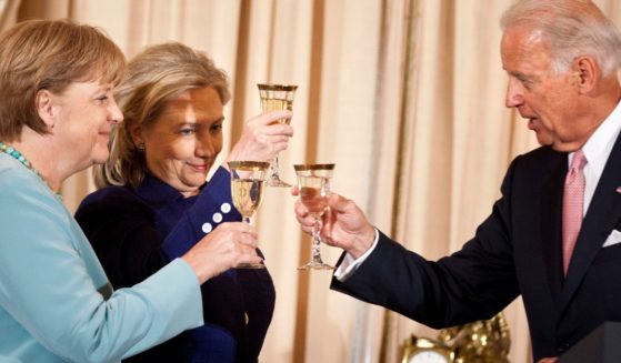 Then-Vice President Joe Biden, right, then-Secretary of State Hillary Clinton, center, and then-German Chancellor Angela Merkel, left, toast during a luncheon at the U.S. State Department in Washington, D.C., on June 7, 2011.