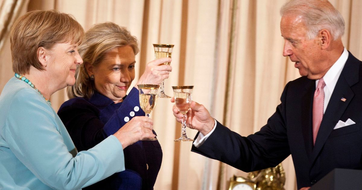 Then-Vice President Joe Biden, right, then-Secretary of State Hillary Clinton, center, and then-German Chancellor Angela Merkel, left, toast during a luncheon at the U.S. State Department in Washington, D.C., on June 7, 2011.