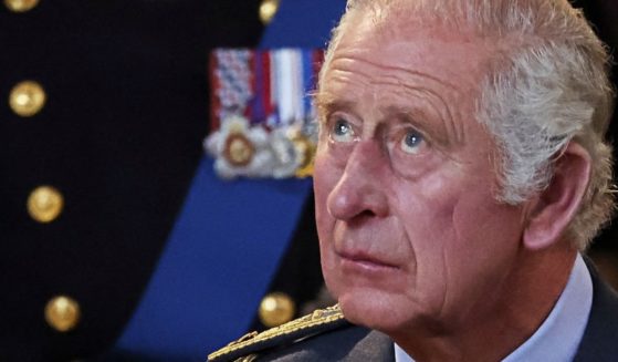 King Charles III looks up at Queen Elizabeth II's coffin inside of Westminster Hall in London on Wednesday.