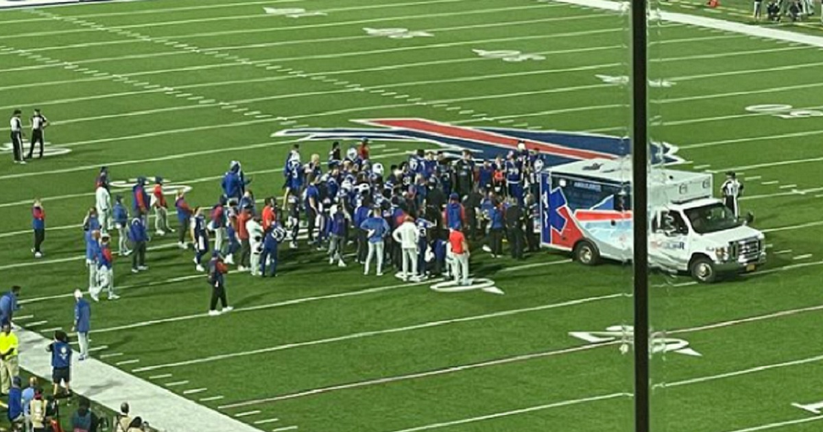 Buffalo Bills players gather around an ambulance that drove onto the field Monday night at Highmark Stadium in Buffalo to pick up injured cornerback Dane Jackson.