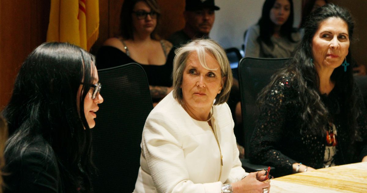 New Mexico Gov. Michelle Lujan Grisham, center, seen in a file photo from June, announced an executive order further expanding her state's abortion services at a news conference Wednesday. The governor is pictured with Planned Parenthood regional spokeswoman Kayla Herring, left, and Democratic state Sen. Linda Lopez of Albuquerque.