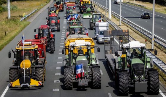 Farmers protest government nitrogen rules by driving their tractors on the A35 motorway near Bornerbroek, Netherlands, on July 28.