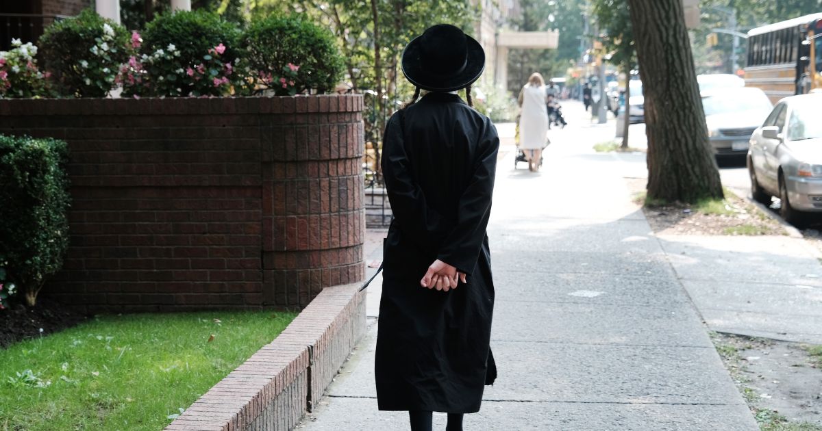 An Orthodox Jewish boy walks down a street on Sept. 12 in the Brooklyn borough of New York City.