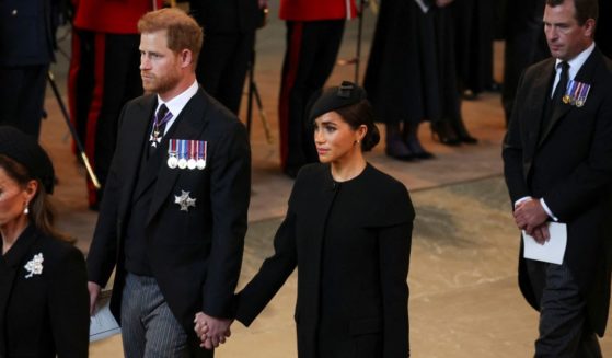 Catherine, Princess of Wales; Prince Harry, Duke of Sussex; Meghan, Duchess of Sussex; and Peter Phillips arrive in the Palace of Westminster after the procession for the lying-in-state of Queen Elizabeth II in London on Wednesday.