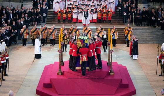 the Bearer Party from Queen's Company, 1st Battalion Grenadier Guards, places the coffin of Queen Elizabeth II on the catafalque, in Westminster Hall