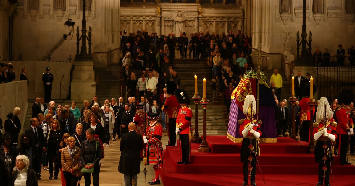 People pay their respects to Queen Elizabeth ll as her coffin lies in state inside Westminster Hall on Friday in London.