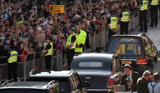 Members of the public gather to see the coffin of Queen Elizabeth II as it leaves from St. Giles' Cathedral in Edinburgh, Scotland.
