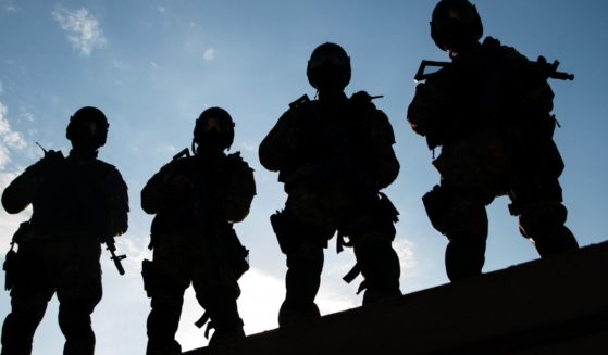 Silhouettes of members of a SWAT team are seen in this stock image.