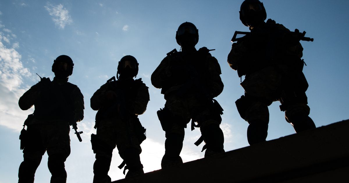 Silhouettes of members of a SWAT team are seen in this stock image.