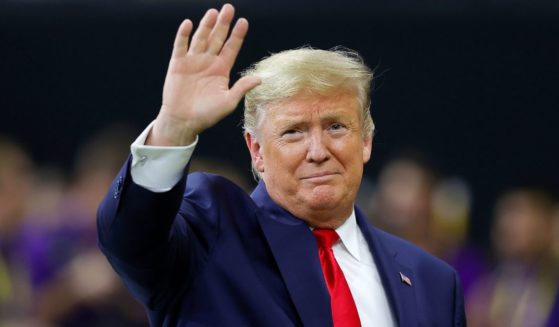 Then-President Donald Trump waves before the College Football Playoff National Championship game between LSU and Clemson at the Mercedes Benz Superdome in New Orleans, Louisiana, on Jan. 13, 2020.
