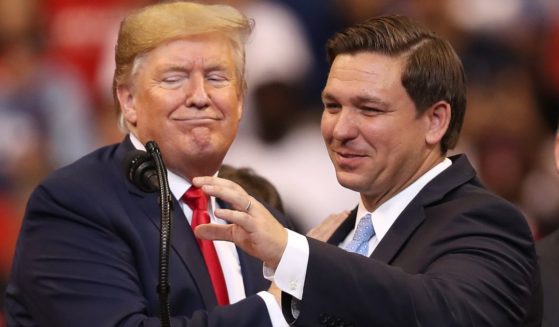 Then-President Donald Trump, left, introduces Florida Gov. Ron DeSantis, right, during a campaign rally in Sunrise, Florida, on Nov. 16, 2019.