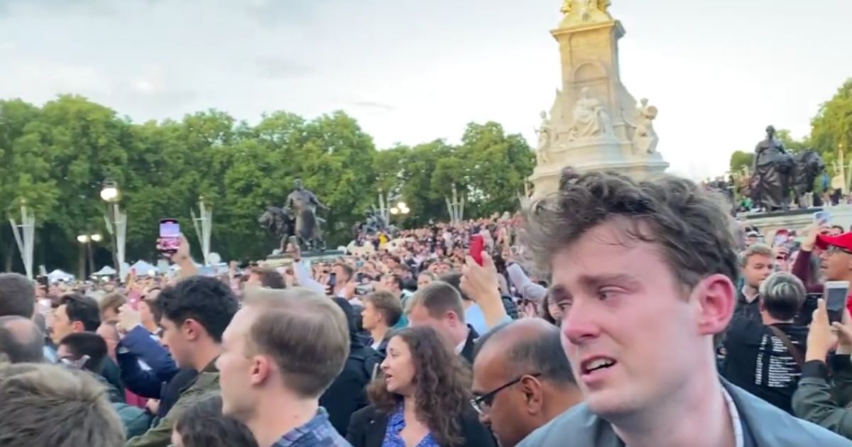 A grieving crowd outside of Buckingham Palace in London on Thursday breaks into "God Save the King," the United Kingdom's new national anthem.