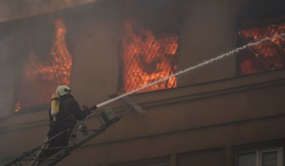 A firefighter works to extinguish a fire after a Russian attack that damaged a police building in Kharkiv, Ukraine, on Monday.