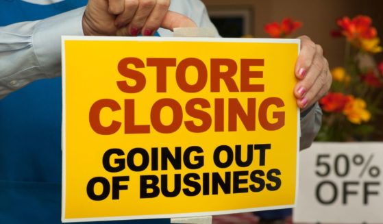 A ohoto illustration shows a "going out of business" sign going up in a store window.