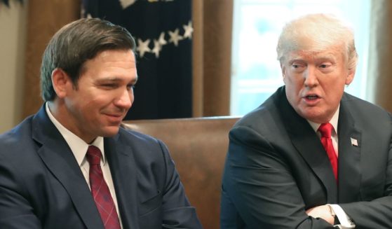 In a December 2018 file photo, then Florida Gov.-elect Ron DeSantis, left, sits with then-President Donald Trump in the Cabinet Room at the White House.